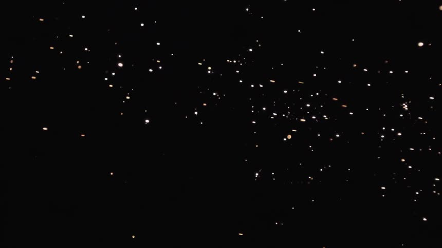 Sparks fly through the night sky