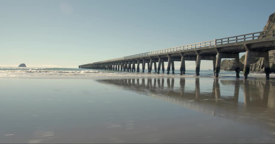 Pier stretching way out into the waters on a clear day