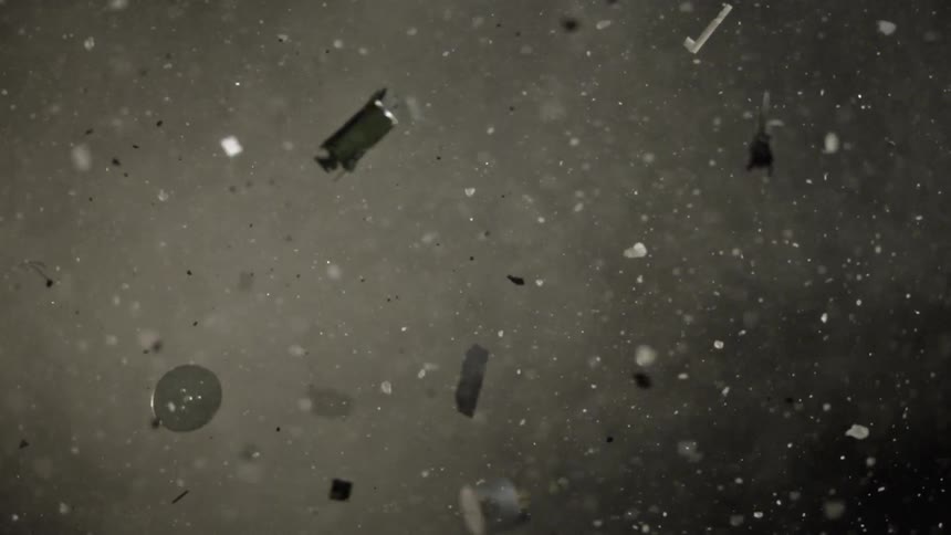 Broken glass and debris fly through the air