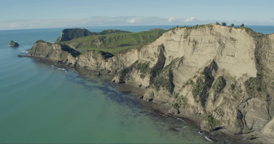 A large island surrounded by water is viewed from a drone