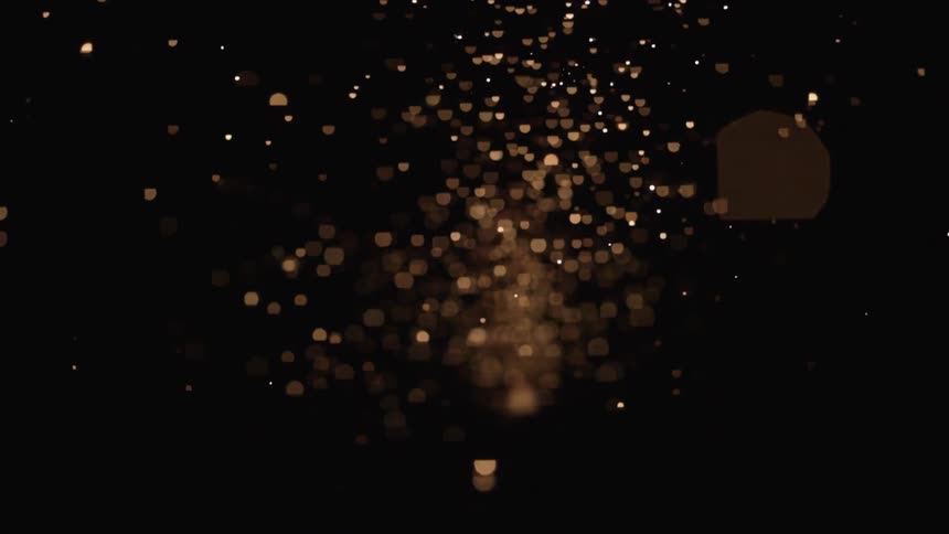 Sparks fly through a dark sky