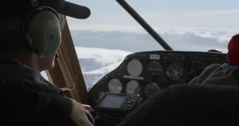 Pilot in cockpit navigates plane