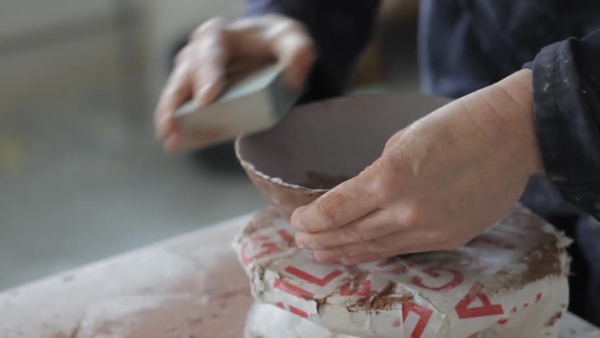 A woman is making a bowl