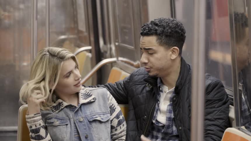 Man and woman talk while riding public transit
