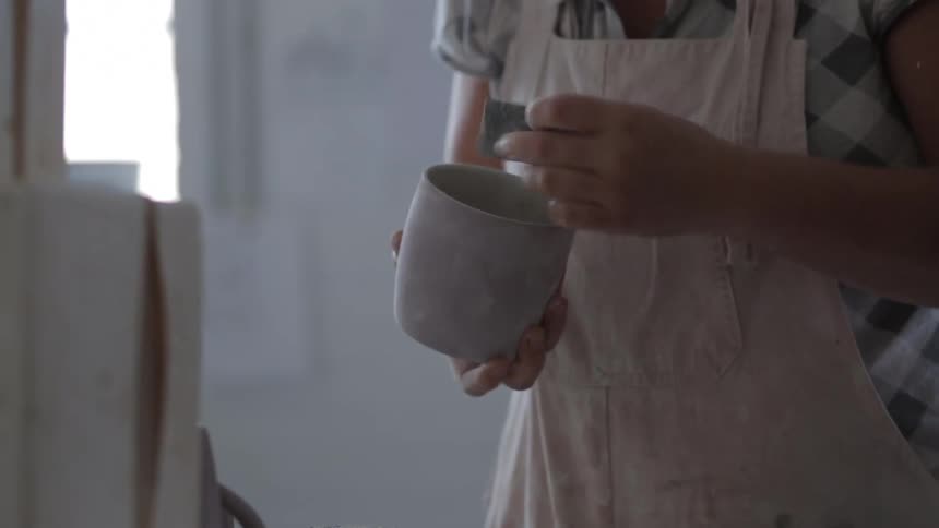 A woman is making pottery