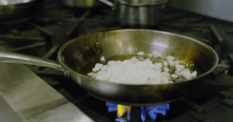 Chopped onions added to a hot frying pan