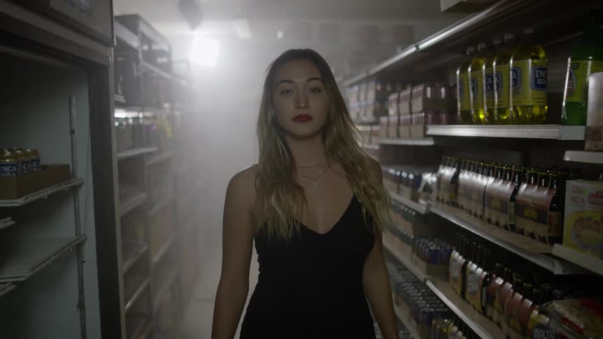 A woman is walking through a foggy store