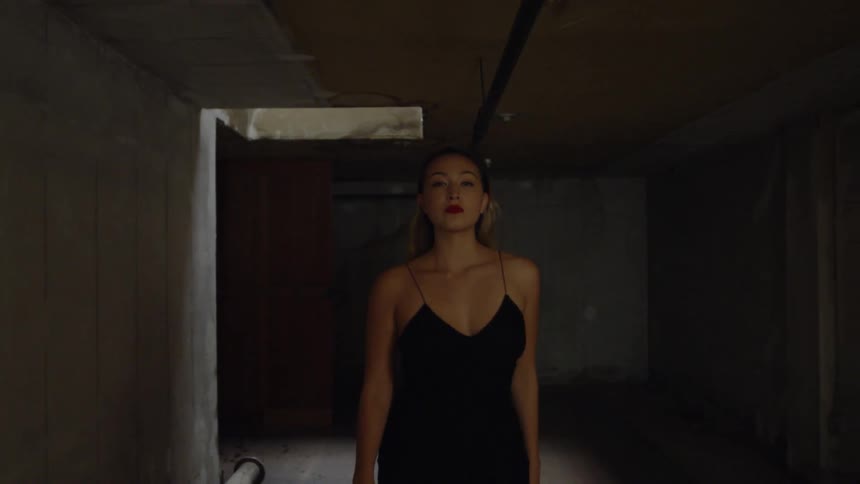 Woman walks in a dark building