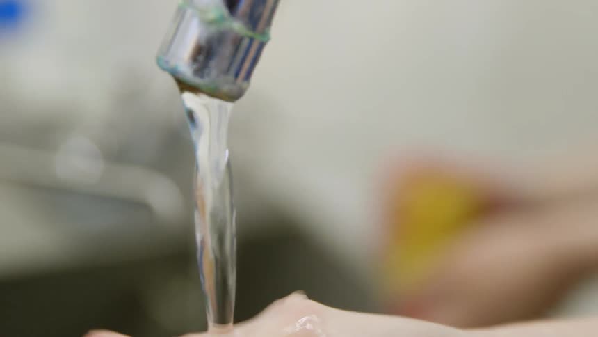 A person is washing their hands with a sponge