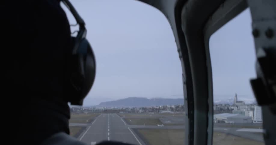 Pilot flies a helicopter near runway