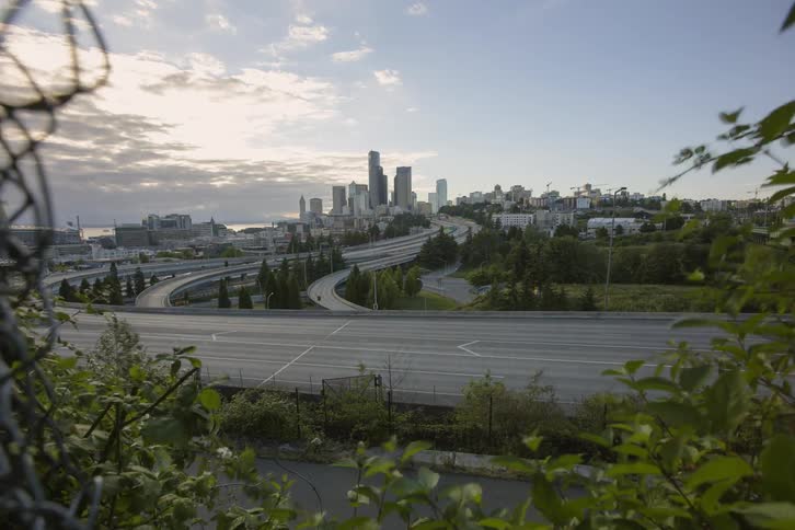 Traffic passes on a freeway during the course of a day