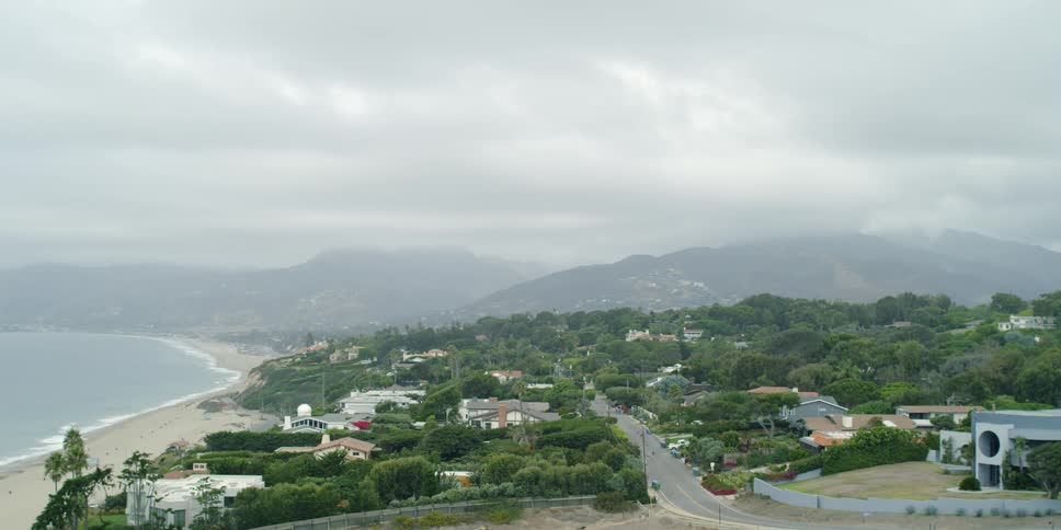 A long road is by the houses near the beach