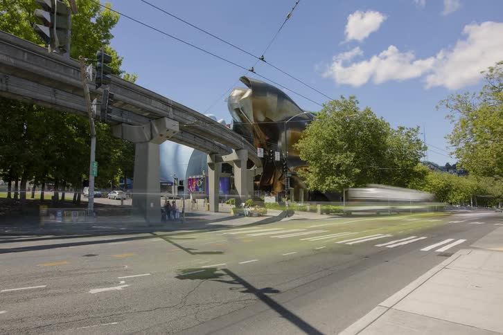 Pedestrians and cars travel on a city street