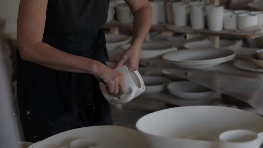 A woman is making pottery
