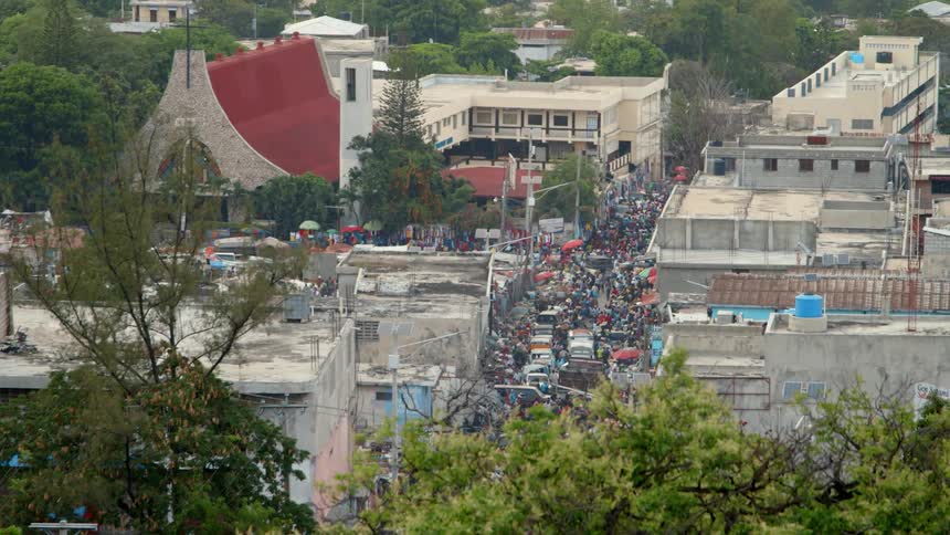A city street is congested with people
