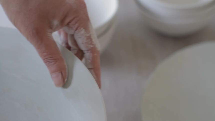 A woman is making a bowl