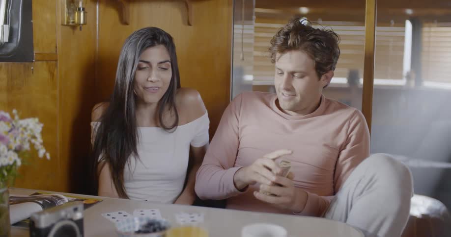 A man and woman are playing cards together