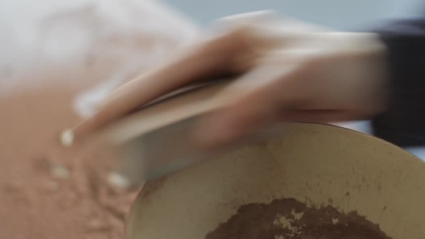 A woman is scratching a bowl