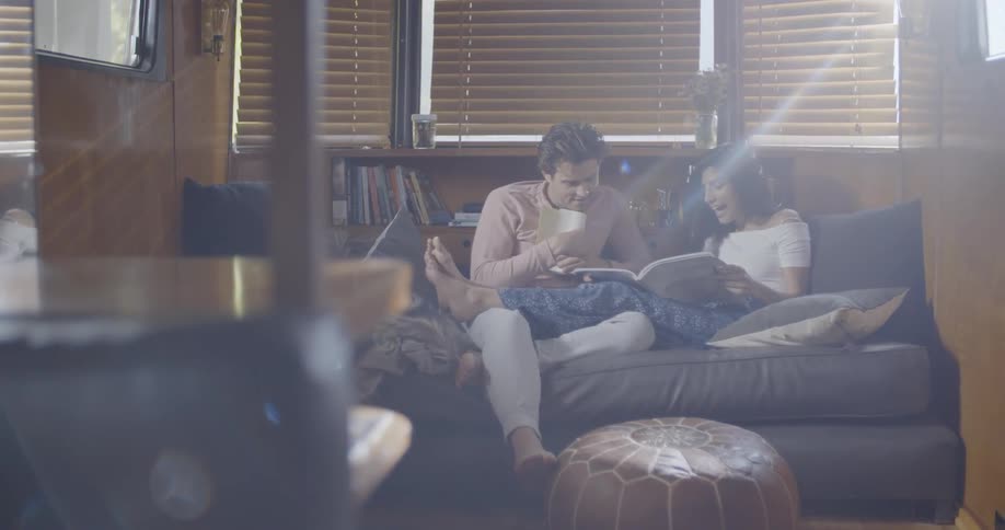 Man and woman read on couch