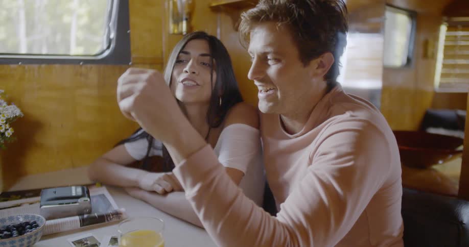 Man and woman sit close together at a table