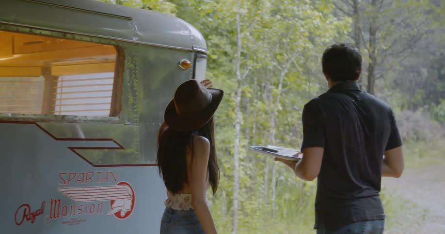Man grabbing plate from woman coming out of a rv