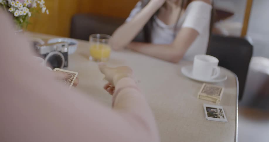 A man deals cards to a girl