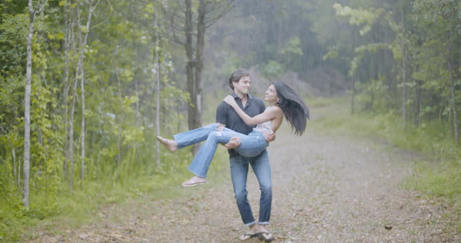 Man spins woman in a rainstorm
