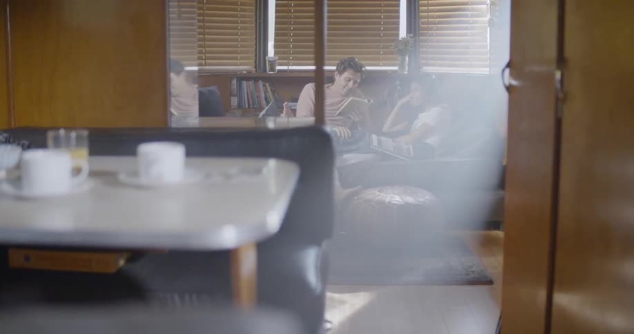 Man and woman read on a couch