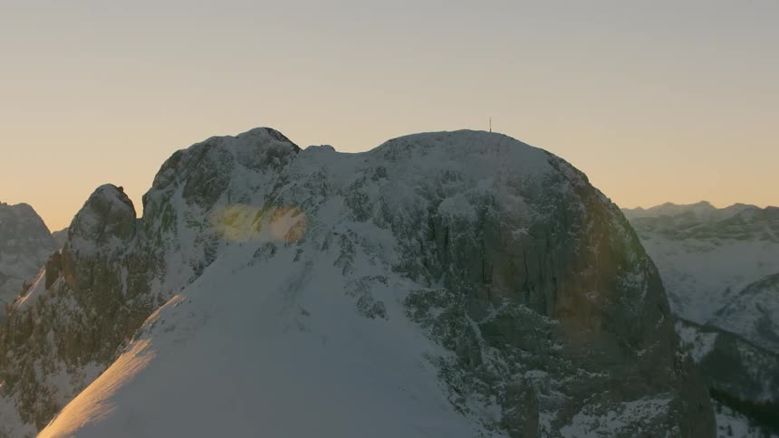 Large mountain covered in snow at sunset