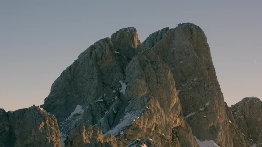 Tall rocky mountains partially covered in snow