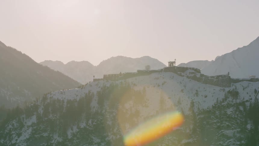 The sun shines on snowy mountains