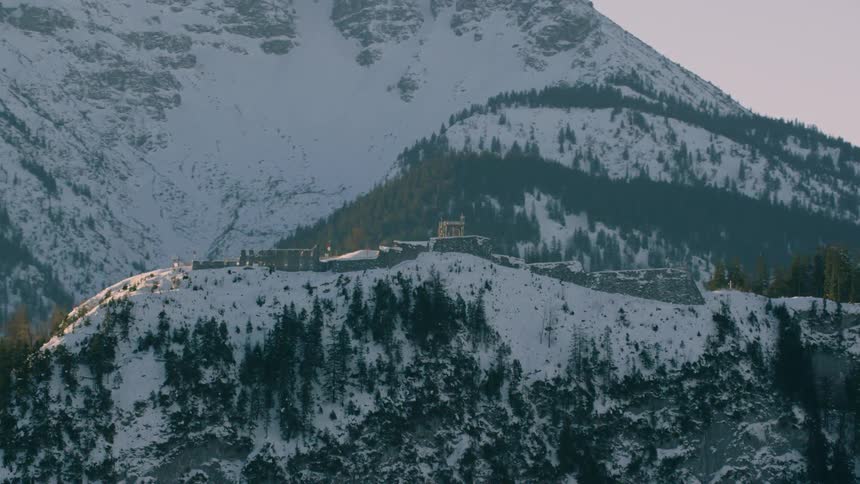 Buildings and houses are on top of this snow covered mountain
