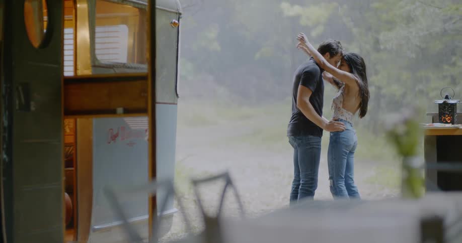 Man and woman embracing outside in the rain