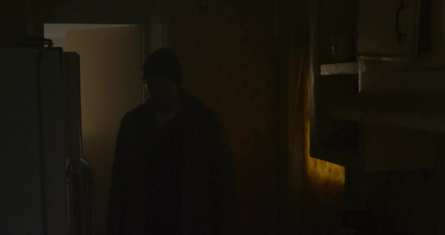 A teenage boy enters a home during the day