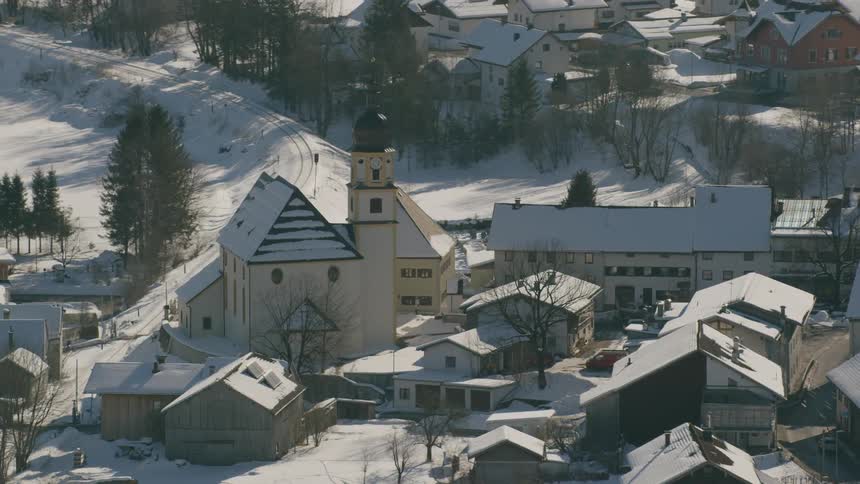 Snow covers the rooftops of a small town