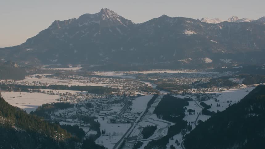 Small town in between mountains is covered in snow