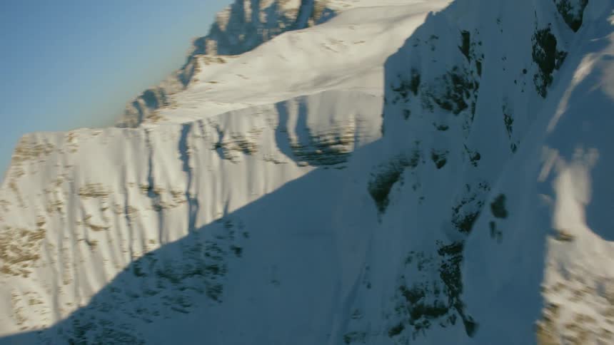Snow covered mountain range on sunny day