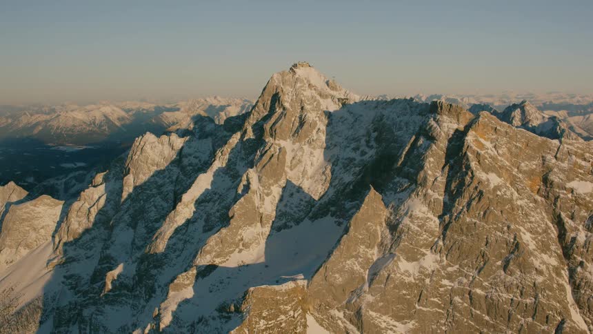 Snow covers a rocky mountain