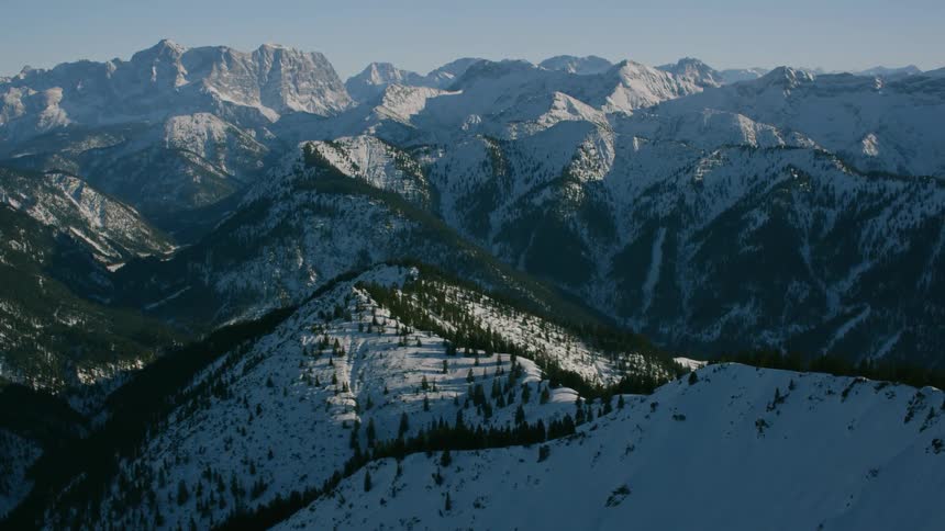 The mountain is covered with ice and has trees all over