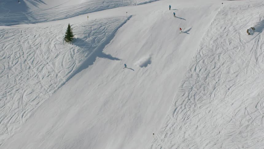 Skiers travel down slopes during the day at a ski resort