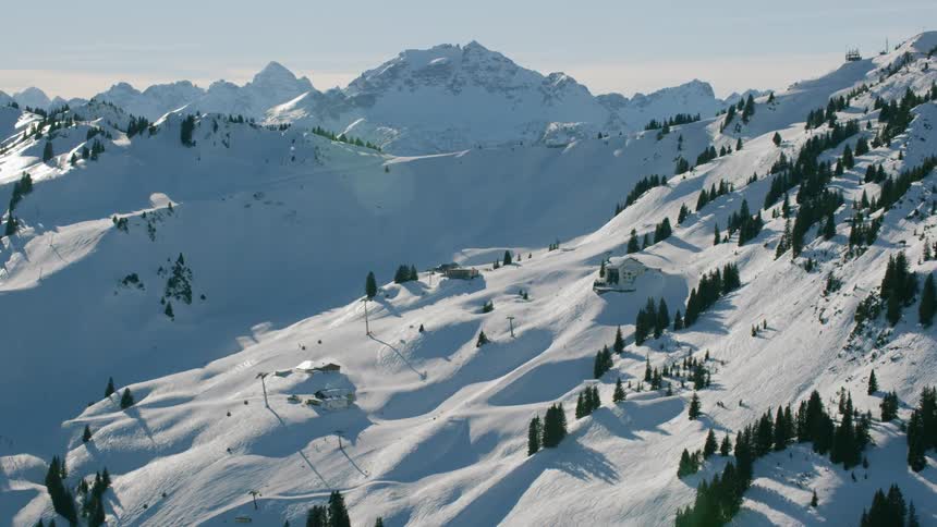 Snow covers mountains on a sunny day