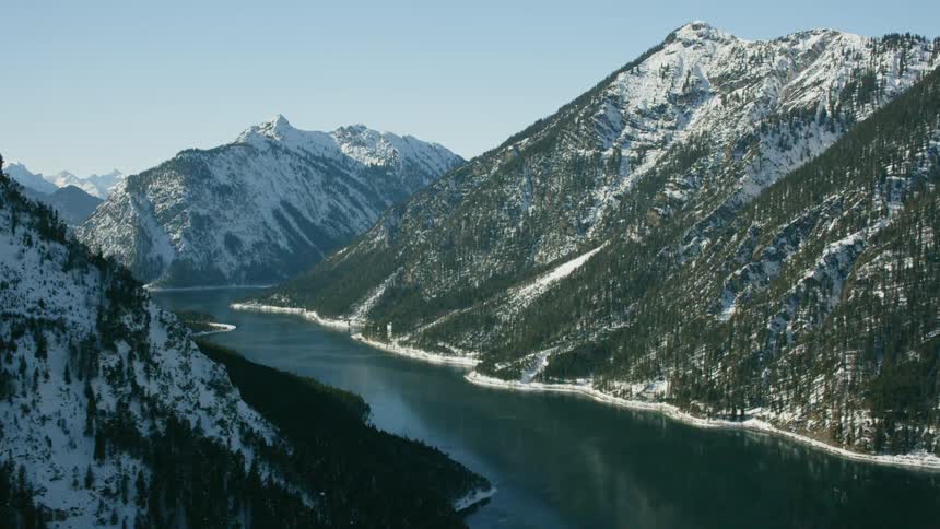 Snow covered mountains on each side of a river