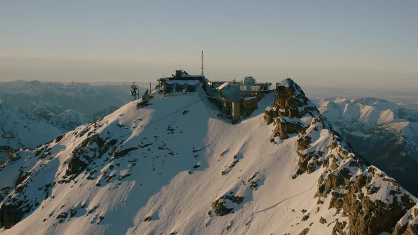 Communications equipment stands on a mountain peak at during the day