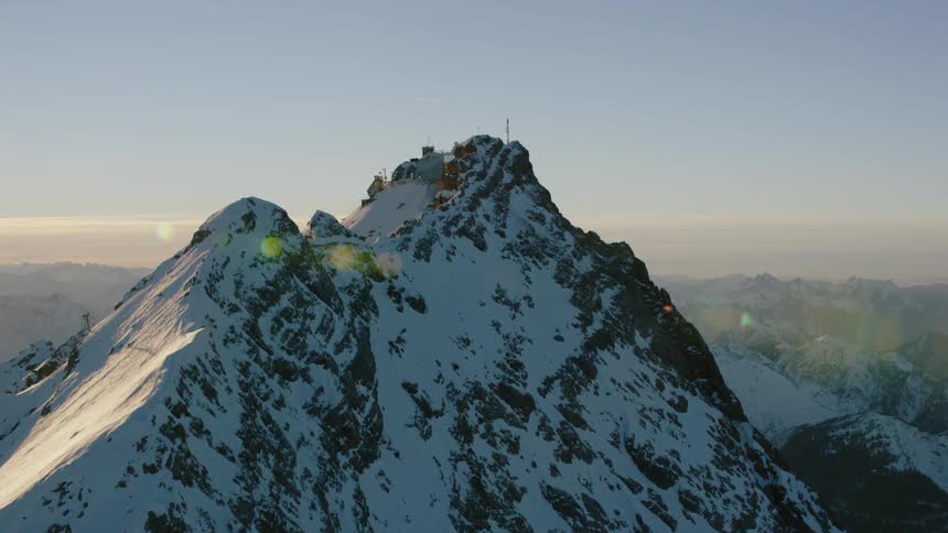 Communications equipment stands on a mountain peak at dawn