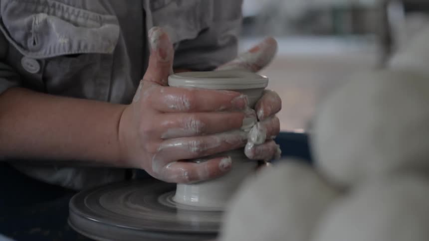 A woman is preparing clay