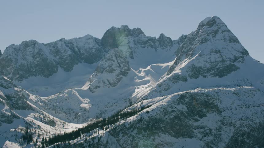 Snow covers a rocky mountain ridge