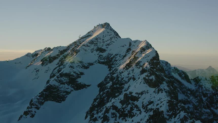 Snow covered mountain peaks at sunset