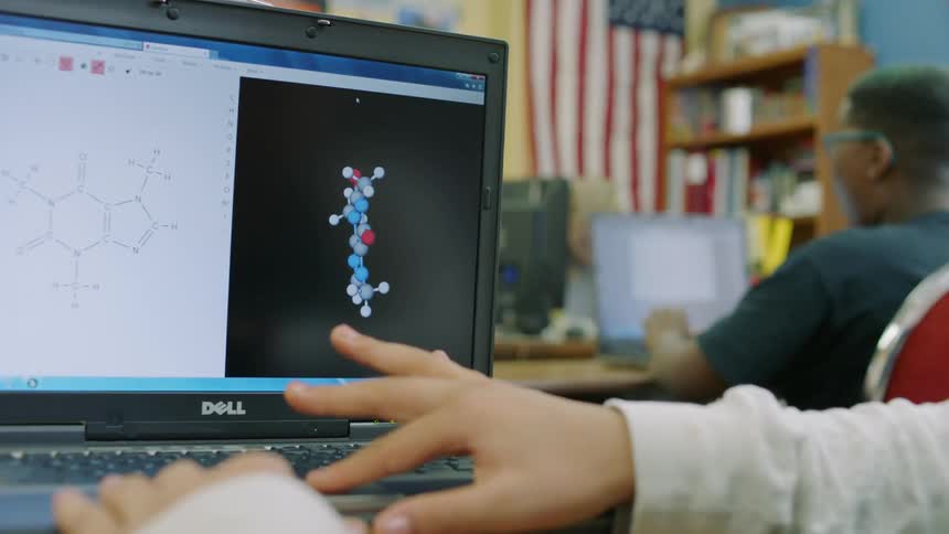 A student looks at an organic molecule on a laptop