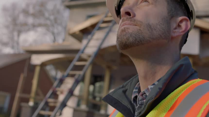 Construction worker holds a controller