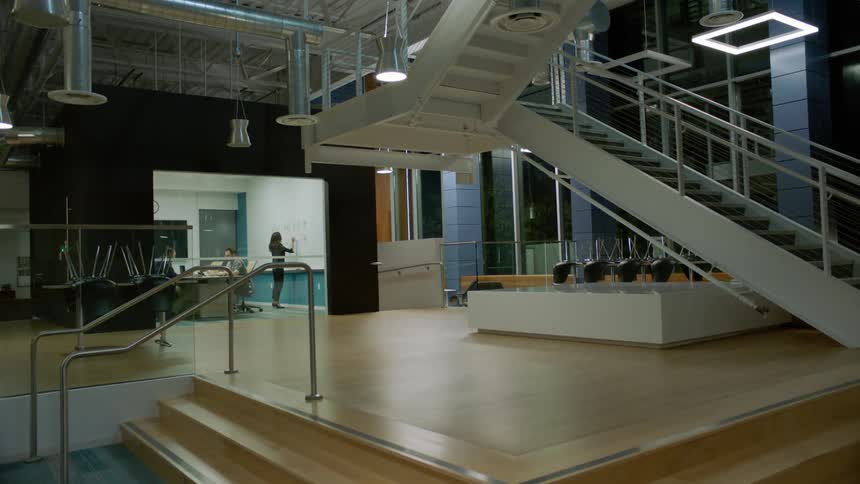 People are working in the far room of this office building